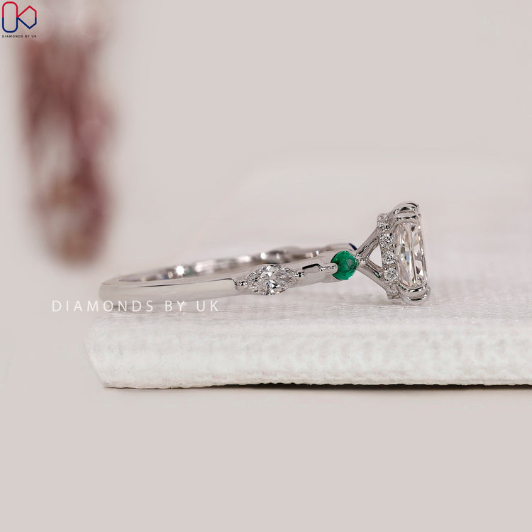 Hidden halo engagement ring with round side stones.
