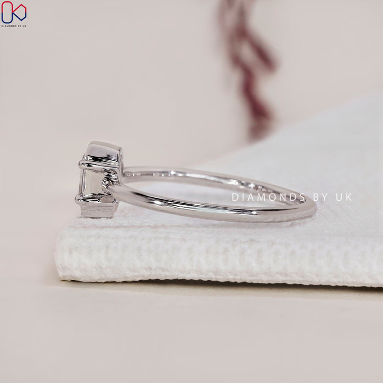 Diamondsbyuk ring with round and emerald cut diamonds for timeless beauty.