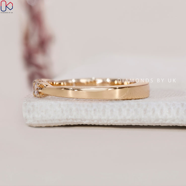 Buy diamond band with round stones and tapered detail.
