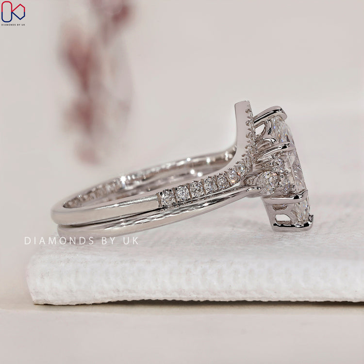 Marquise diamond with round side stones for added brilliance.
