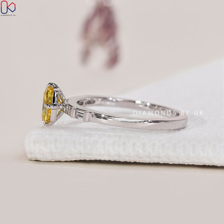 Compass prong setting with yellow cushion diamond ring.
