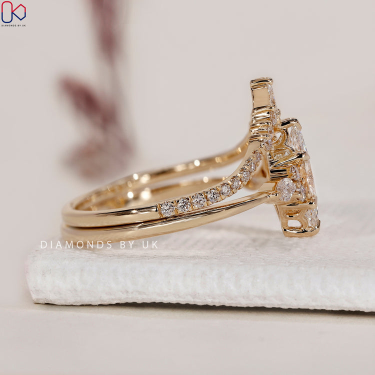 Marquise diamond with round side stones for extra brilliance.
