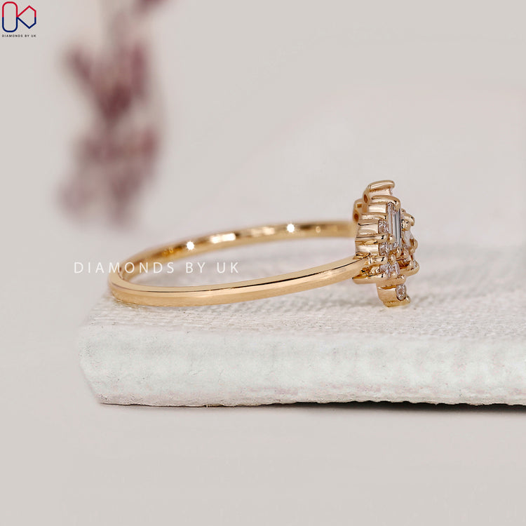 Yellow gold engagement ring with round and baguette diamonds.

