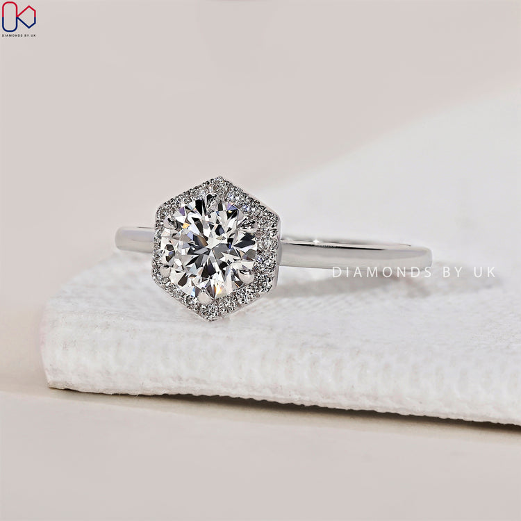 Handmade ring featuring a round cut diamond in a prong setting ring.
