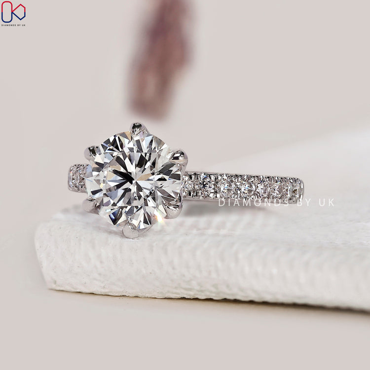 6 prong claw setting engagement ring with a round diamond.
