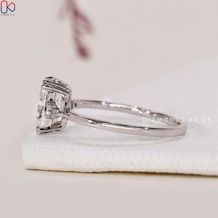 Handmade ring featuring a radiant cut diamond with a 5 stone design.