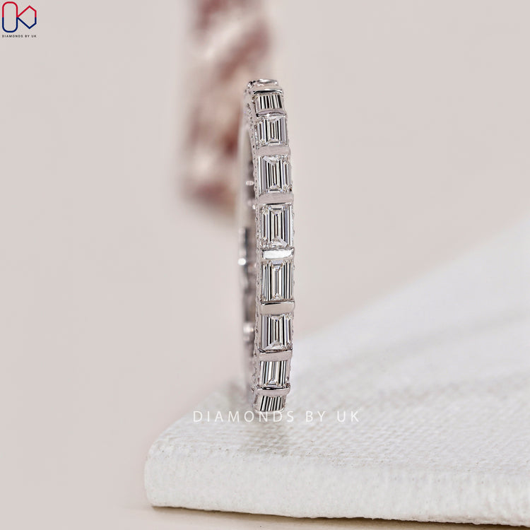 Minimalist wedding band with sleek design and delicate diamond accents.

