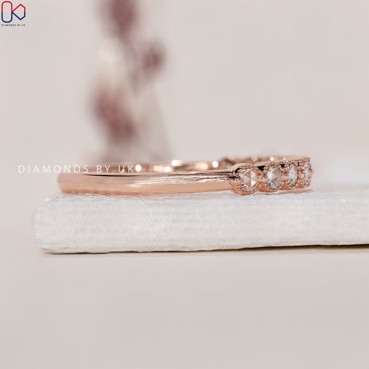 Milgrain wedding band with delicate detailing and round diamonds.
