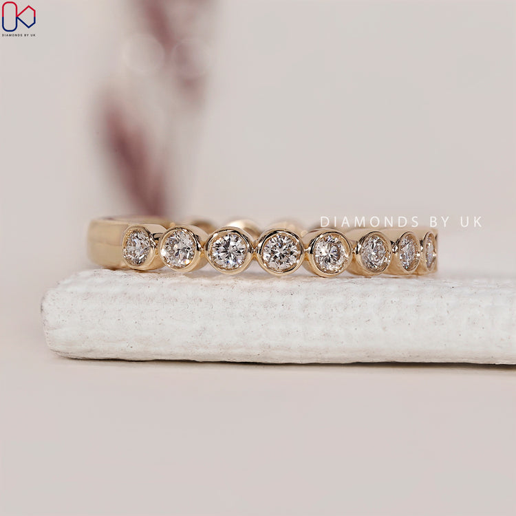 Half eternity band with diamonds set halfway for an elegant touch.
