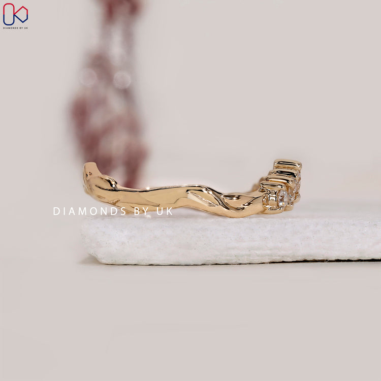 Buy yellow gold curved diamond wedding band online.
