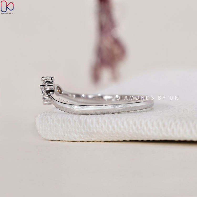 Prong set wedding band showcasing securely placed diamonds for maximum brilliance.
