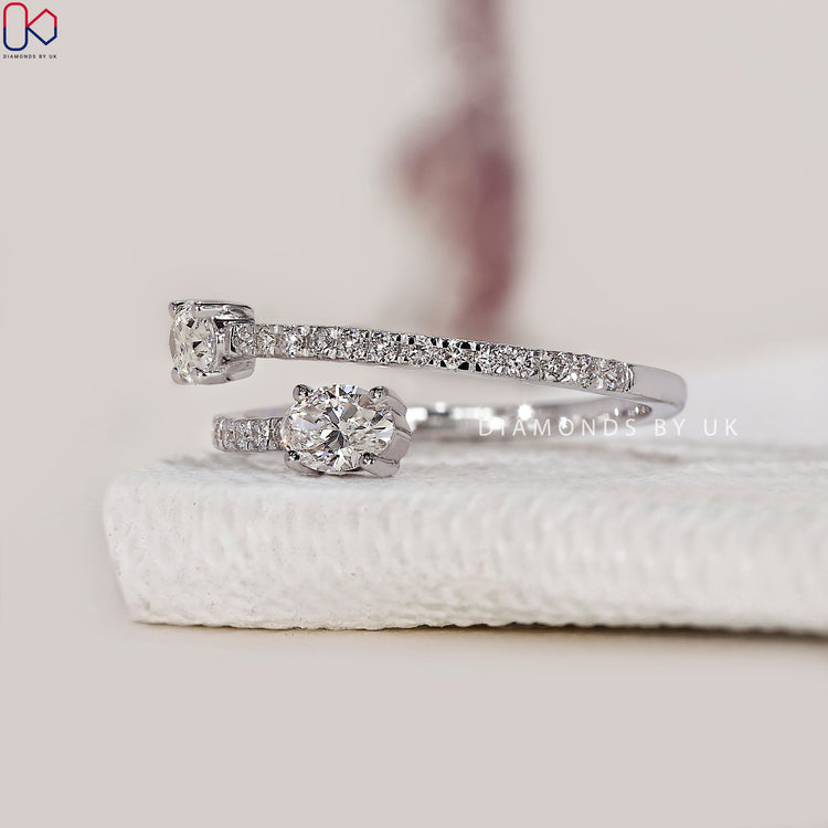 Bypass oval engagement ring with delicate design.

