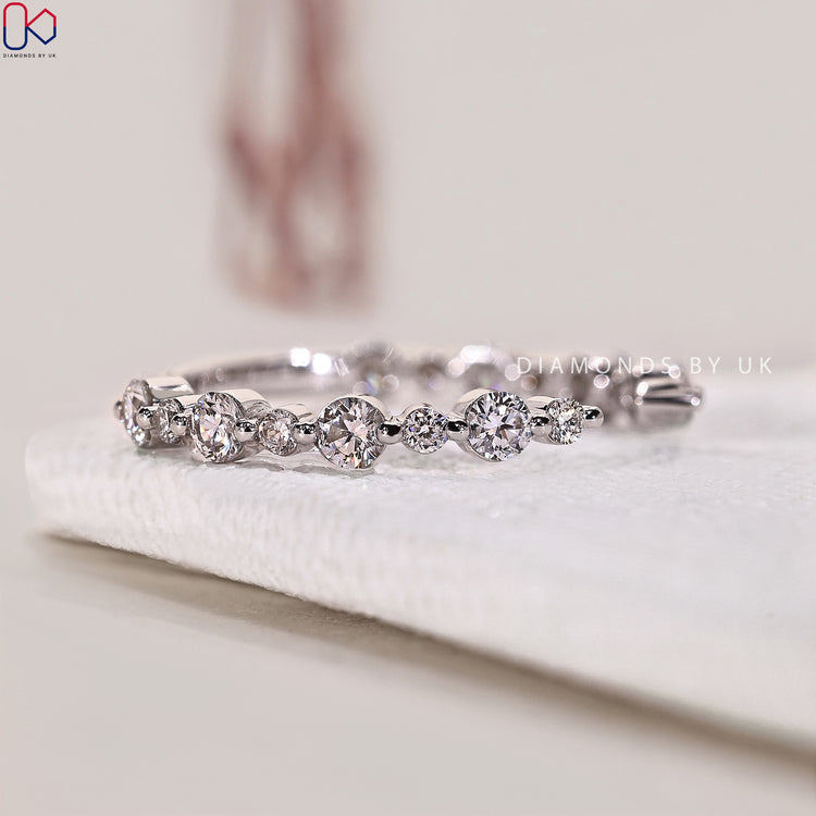 A prong setting wedding band crafted from white gold and adorned with lab grown diamonds.