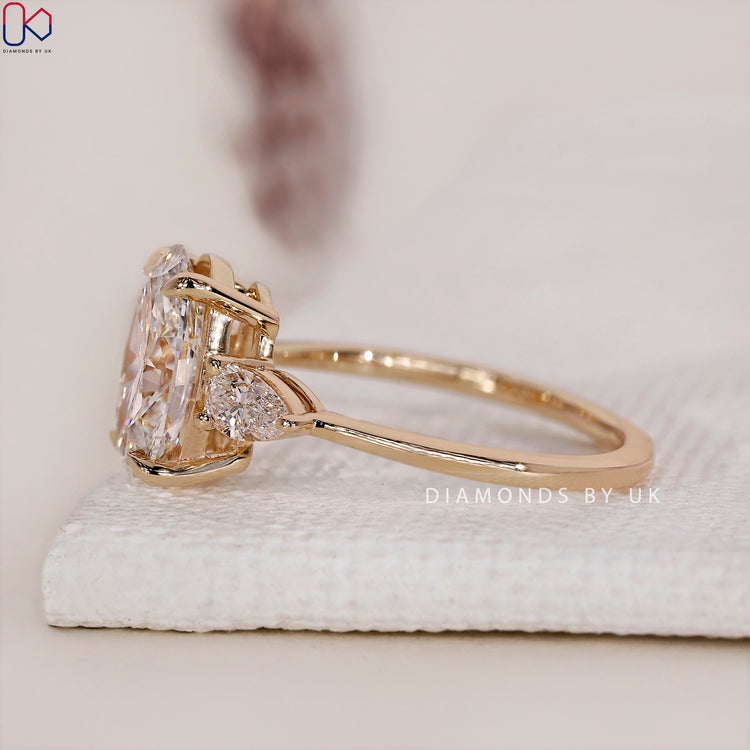 Buy engagement ring featuring a stunning 3 stone diamond engagement ring with a yellow gold band.
