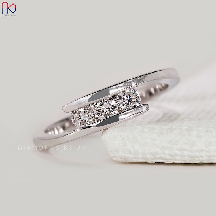 Custom diamond band with 3 round cut stones.
