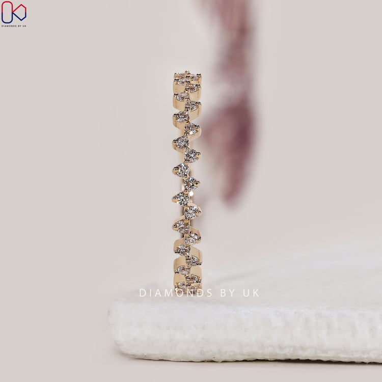 Prong set wedding band with lab grown diamonds shaped into a unique wave.