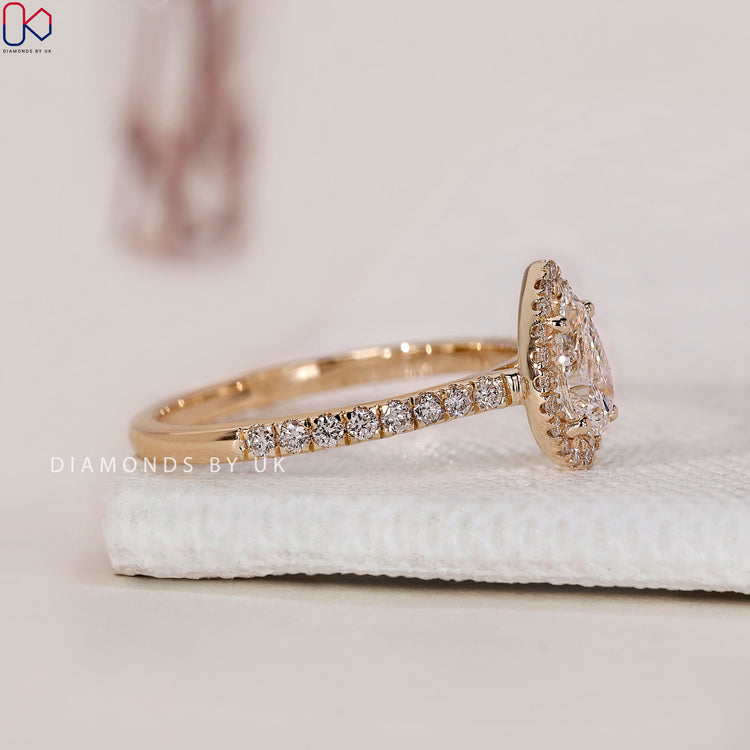 Lab Grown Diamond pear shaped engagement ring with a pave diamond ring setting.
