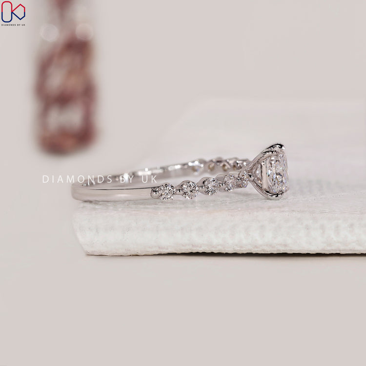 Diamondsbyuk ring featuring a white gold cushion cut shared prong eternity design.