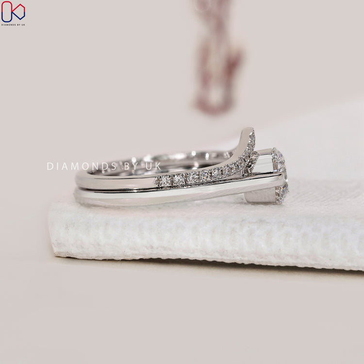 Half eternity diamond band with solitaire engagement ring in white gold.
