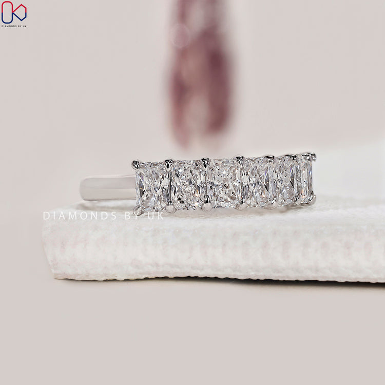 Claw prong setting band with sparkling radiant cut diamonds.
