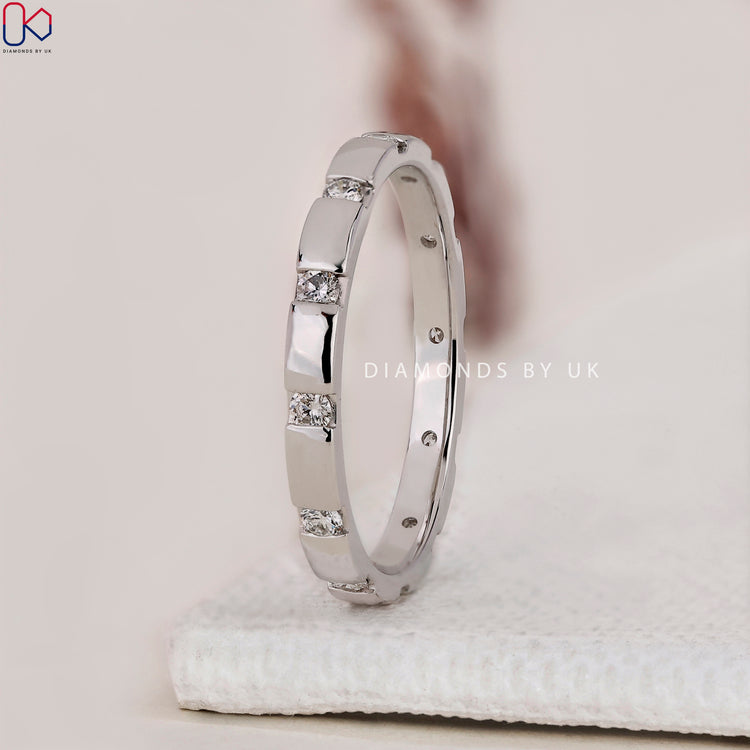 DiamondsbyUK gypsy setting wedding band in white gold.
