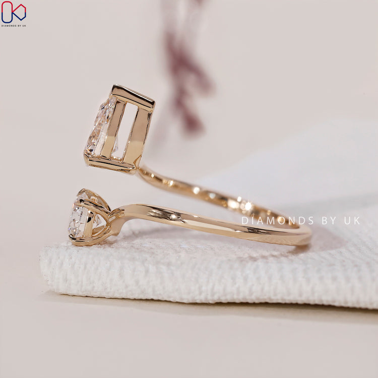 Claw prong setting showcasing a pear and round diamond ring.