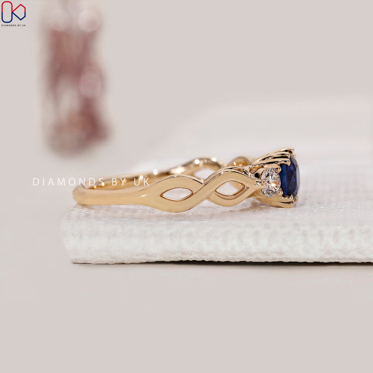 Yellow gold diamond ring with cushion cut sapphire.
