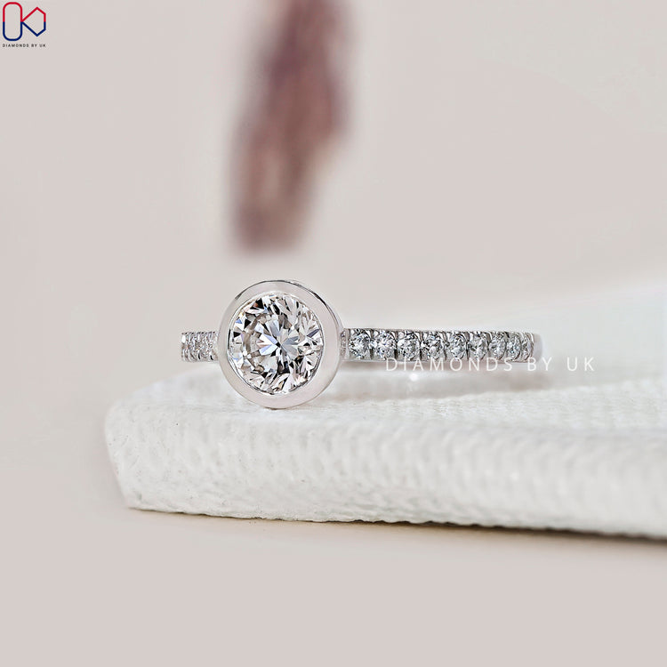 Bezel setting round diamond ring, handmade in white gold.
