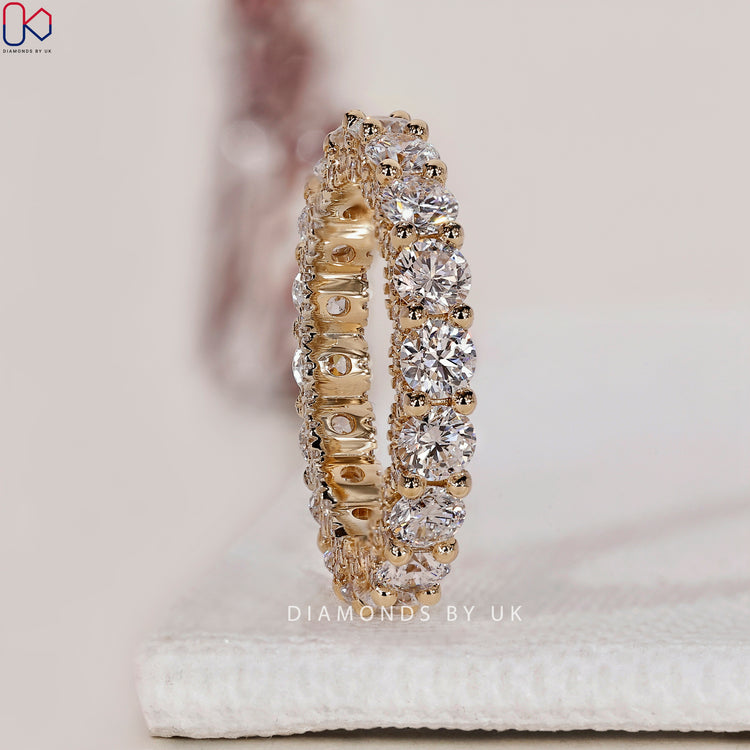 Prong setting band showcasing full diamond eternity for a secure, classic design.
