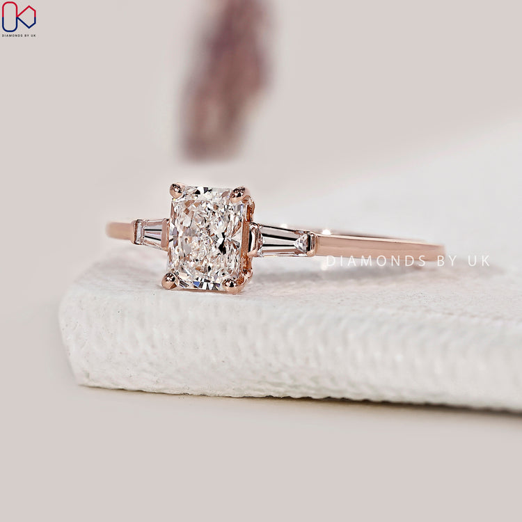 Rose gold ring with a stunning radiant cut diamond centrepiece.
