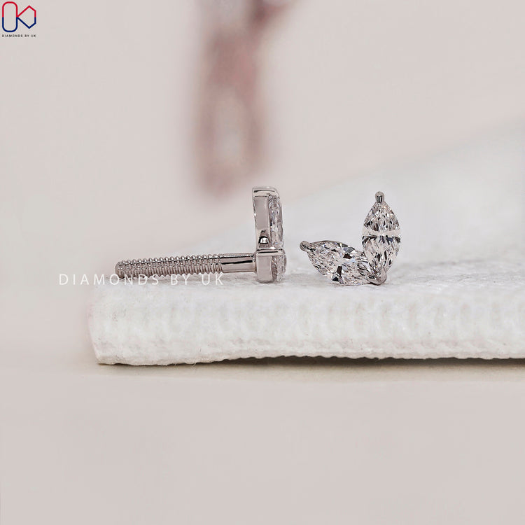 White gold earrings with a radiant marquise diamond setting.
