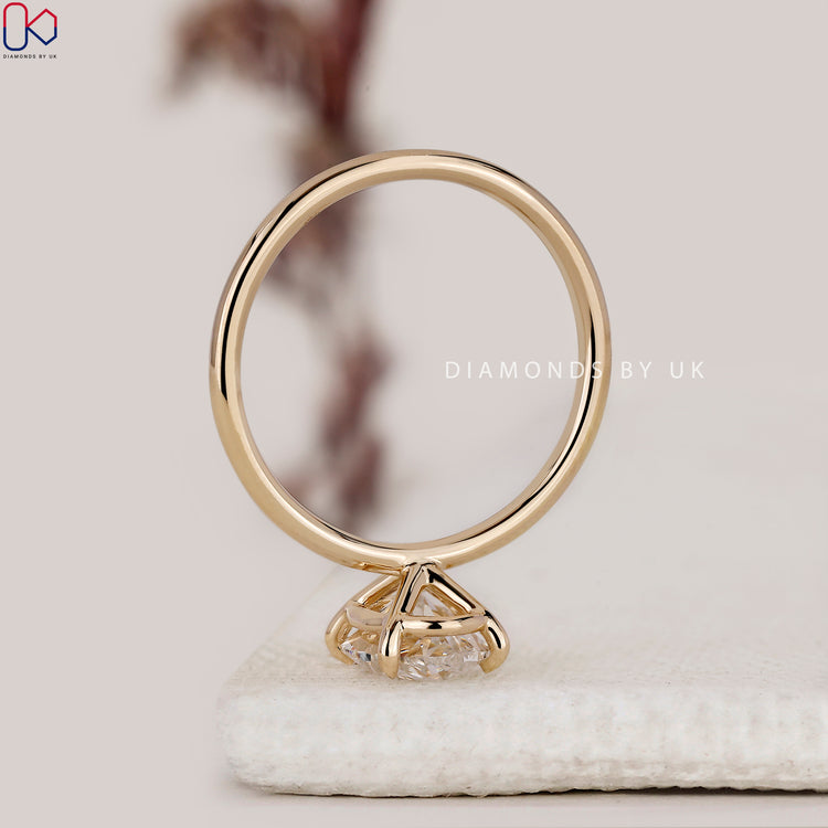Yellow gold engagement ring with oval solitaire design.
