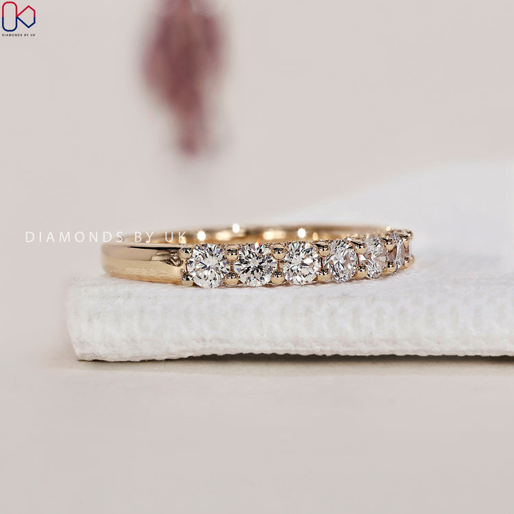 Round diamond wedding band featuring timeless elegance and brilliance.
