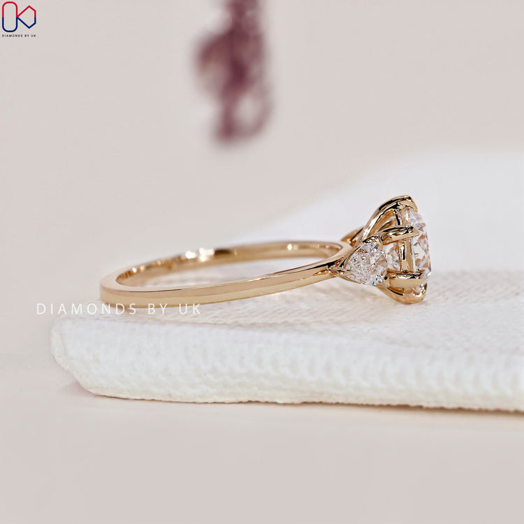 Yellow gold ring featuring a beautiful 3 stone diamond engagement ring design.
