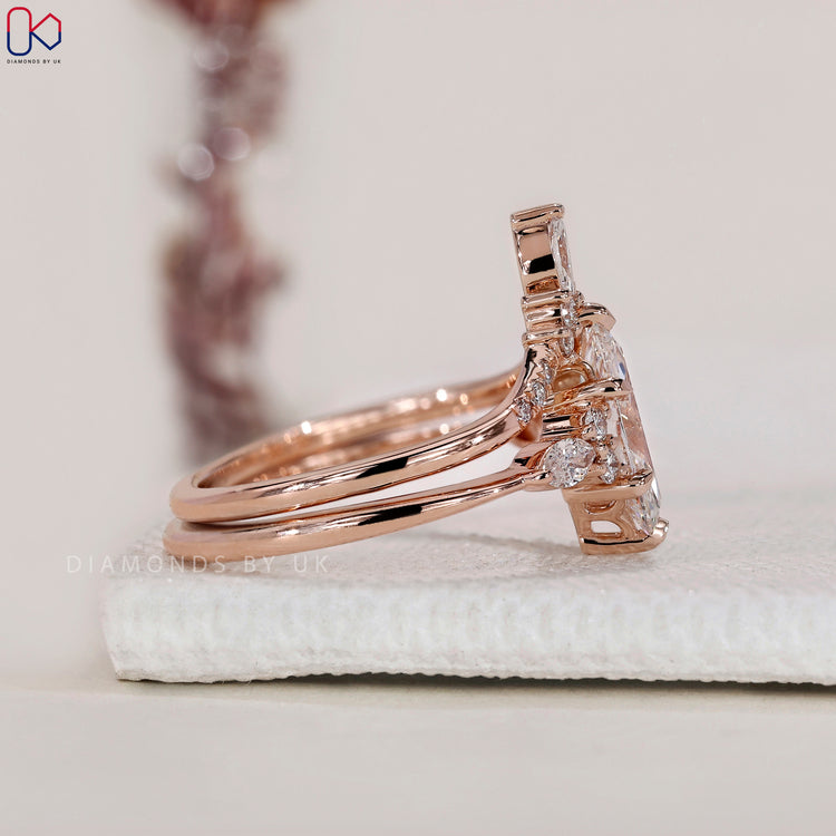 Marquise and round diamond band in rose gold.
