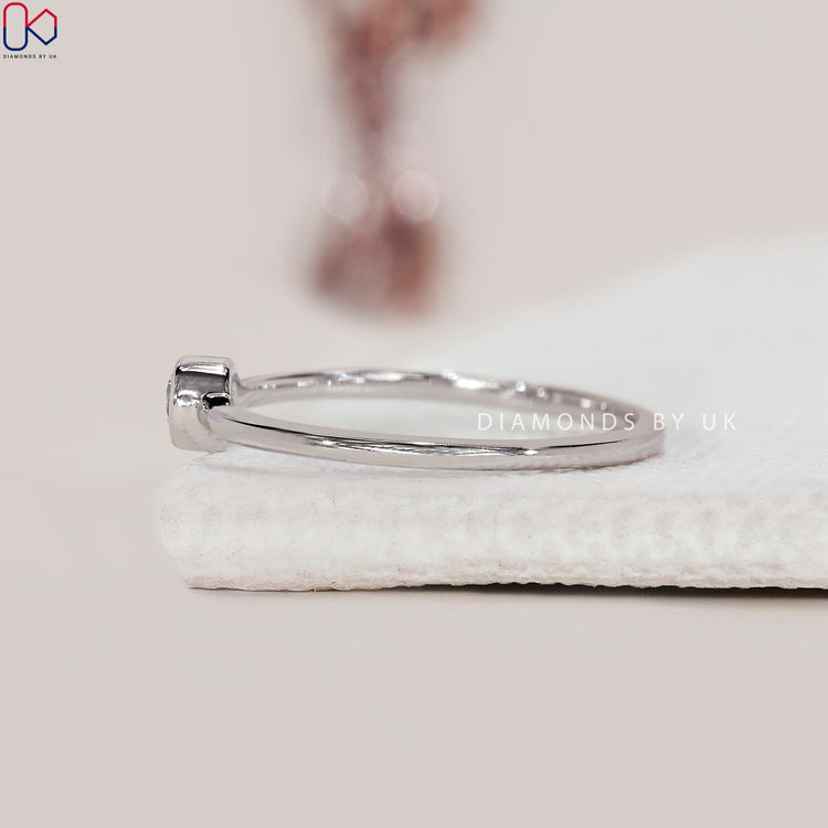 Handmade ring with a round cut diamond and white gold.
