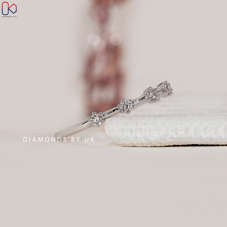 Diamondsbyuk white gold prong set diamond band.
