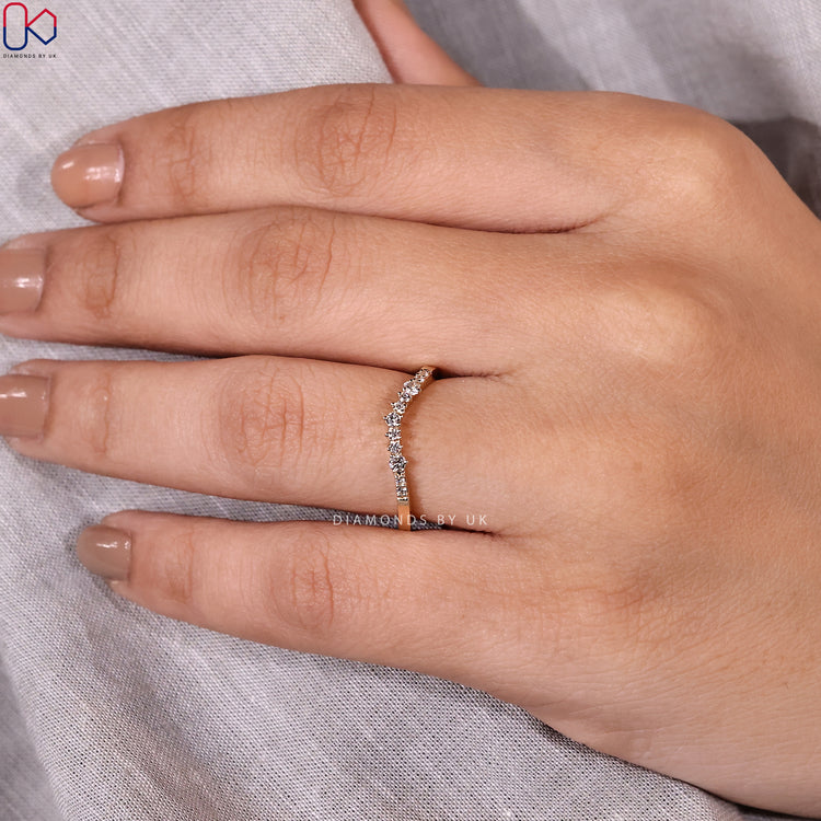 Curved diamond wedding band paired with round cut diamond band
