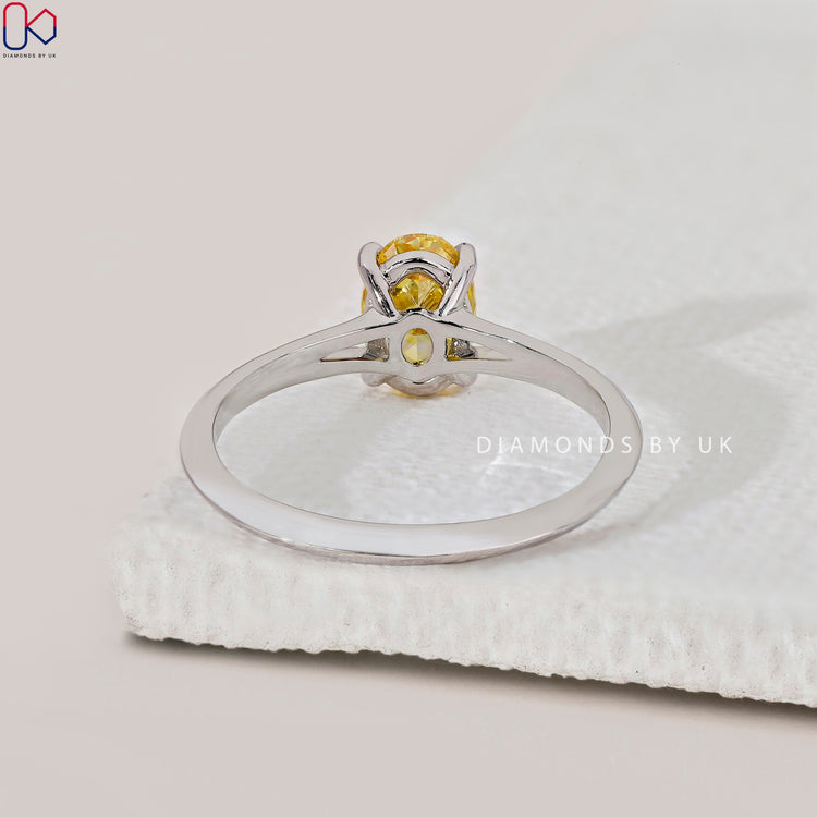 Lab-grown diamond engagement ring with oval cut.
