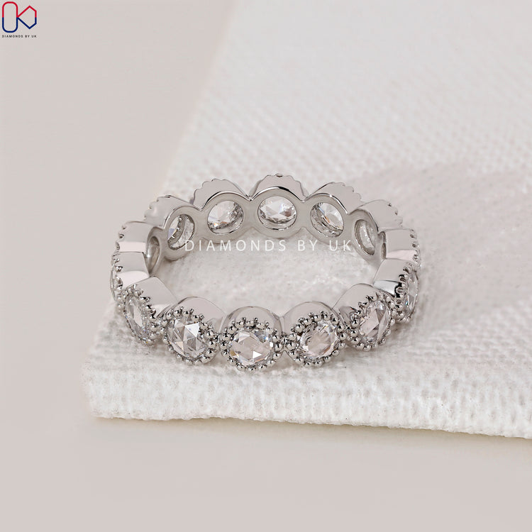 Simple lab grown diamond wedding band in bezel style.
