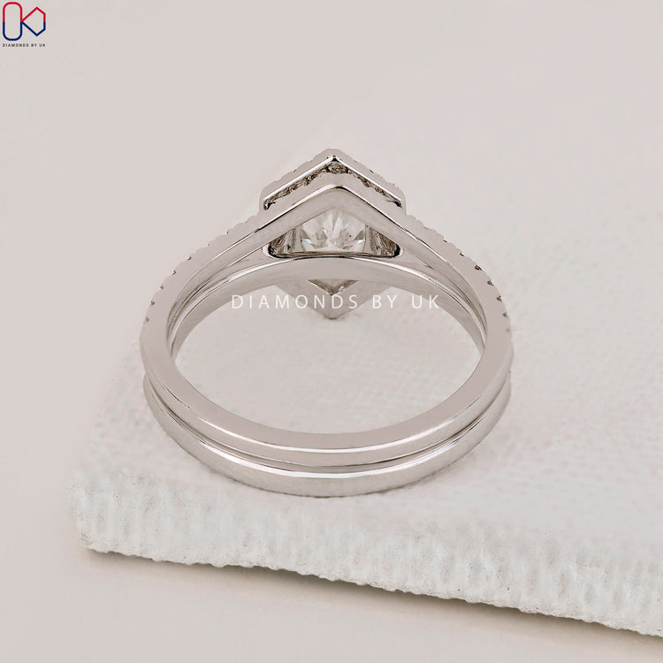 White gold bridal set with halo engagement ring and curved diamond band.
