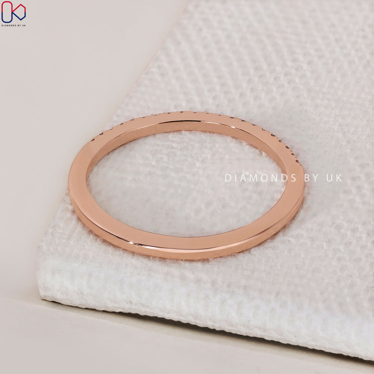 Beautiful rose gold wedding band featuring a pave diamond design.
