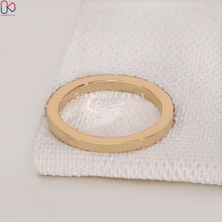 Elegant two tone wedding band with round diamond accents.
