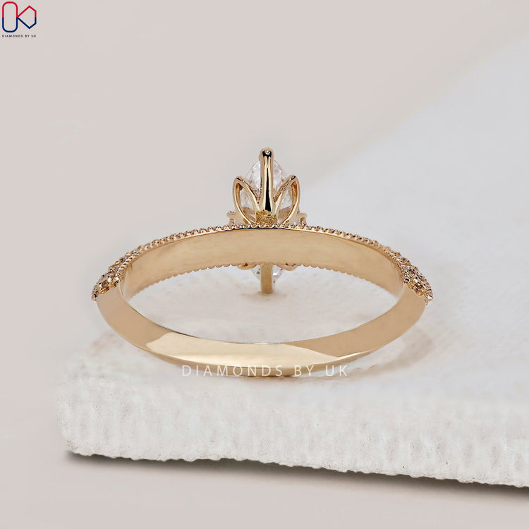 Diamondsbyuk ring showcasing a marquise diamond and pave set.
