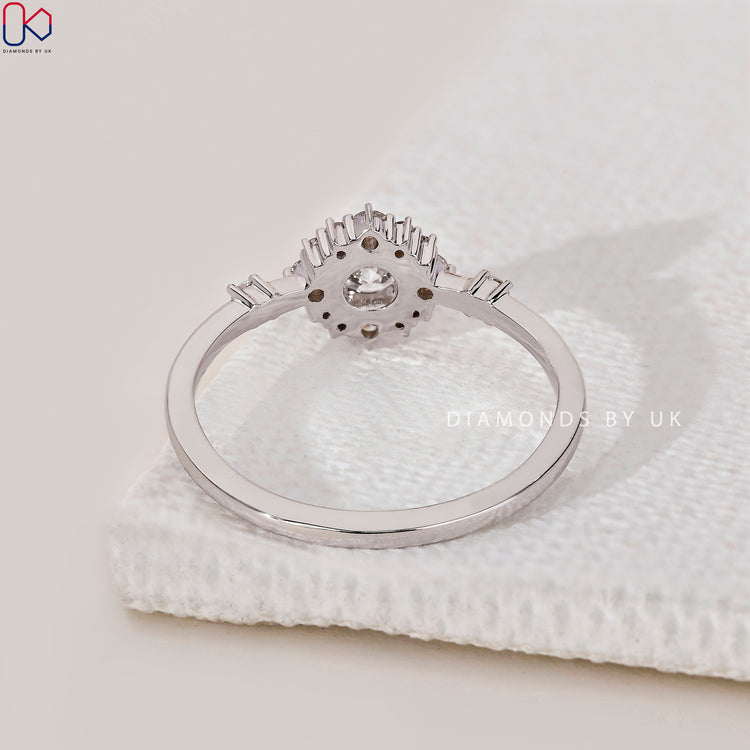 Customise your engagement ring with a round diamond and side stones.
