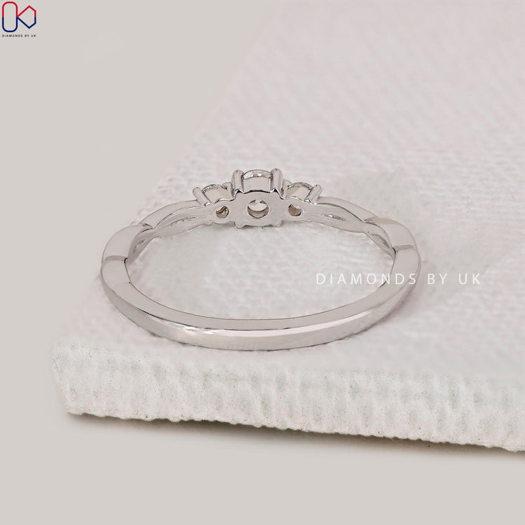 Handmade jewelry featuring a 3 stone round diamond engagement ring.
