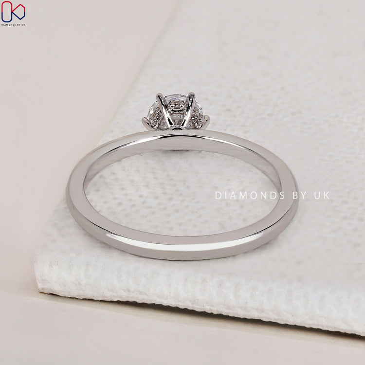 Stunning handmade ring featuring a classic round solitaire engagement ring design.