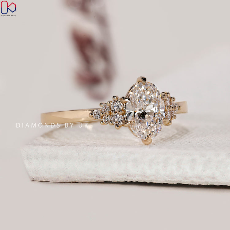 6 claw prong setting holding lab grown oval diamond.
