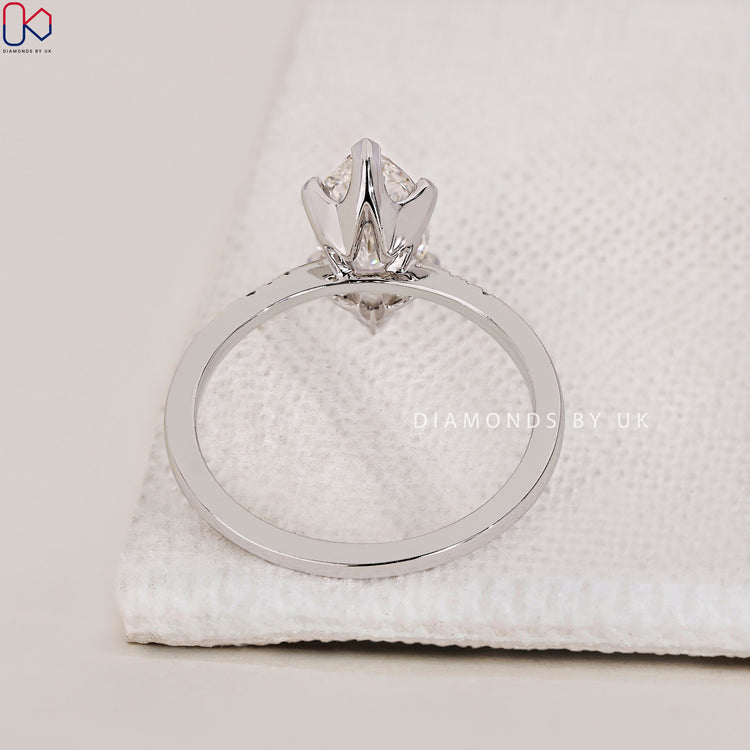 Lab Grown Diamond Marquise Engagement Ring with round side diamonds, set in a 4 prong claw setting for a refined look.
