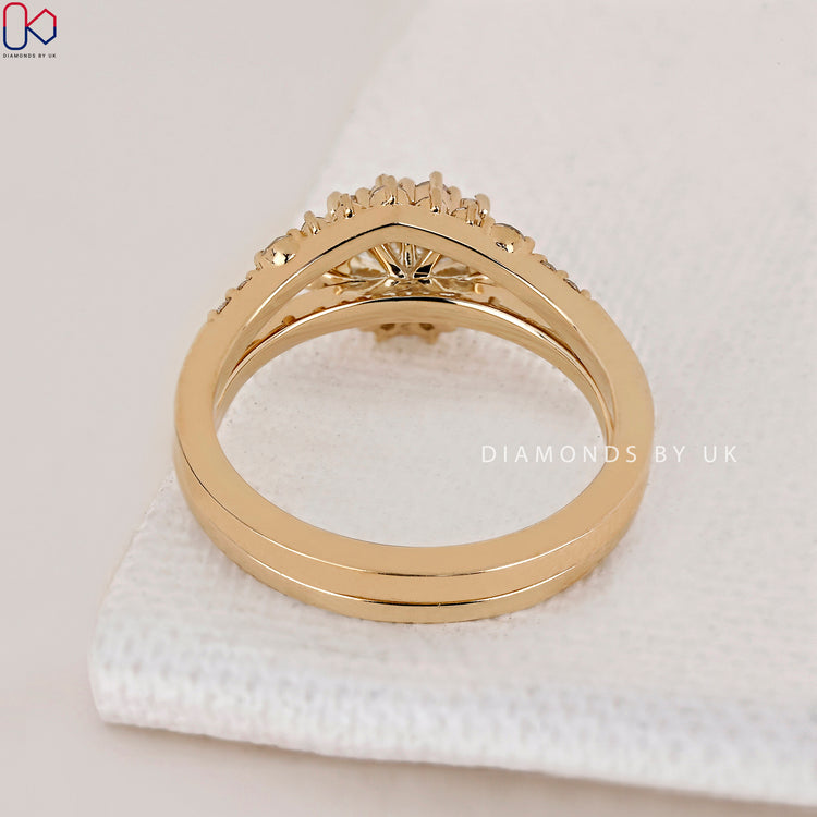 Curved wedding band yellow gold with round cut diamond side stones.

